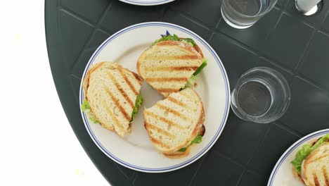 Delicious-toast-sandwiches-in-white-plate,-top-down-view