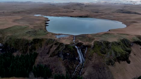Scenic-Landscape-Of-Systrafoss-Waterfall-And-Lake-Systravatn,-Kirkjubæjarklaustur,-Iceland---Drone-Shot
