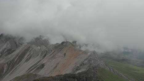 Drone-captures-the-ridge-of-the-Monzoni-range-during-a-cloudy-day,-following-the-Via-Ferrata-Federspiel