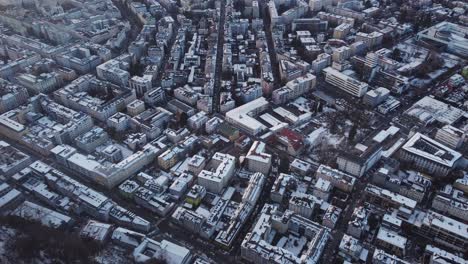 Aerial-top-view-of-snow-white-covered-cityscape-buildings-in-Salzburg-city