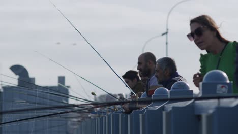 Cinematic-closeup-of-Turkish-fishermen-fishing-at-the-famous-Galata-Bridge