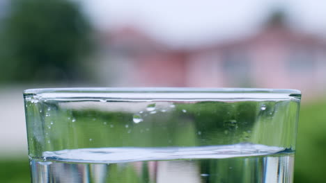 Detail-of-water-drops-falling-inside-a-glass-cup
