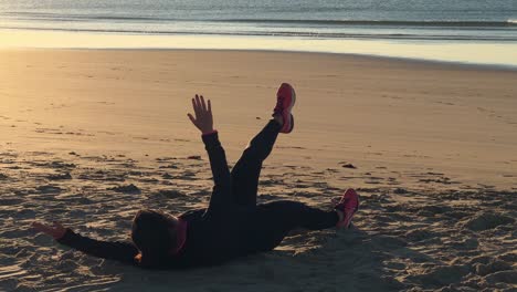The-woman-exudes-vitality-as-she-exercises-along-the-sea-beach,-embodying-the-essence-of-fitness-and-recreation