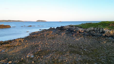 Guernsey-North-East-coast-panning-shot-across-Little-Russell-Channel-across-to-Herm-and-Jethou-and-view-of-St-Sampson-in-distance-with-Vale-Castle-over-rocky-shoreline