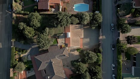 Aerial-Establishing-Shot-Above-Green-European-Neighborhood-Houses,-Streets-Swimming-Pools,-Roads-and-Tile-Red-Roofs