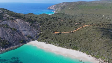 Aerial-view-of-hidden-beach-in-Albany-Western-Australia-with-mountain-views-in-the-background