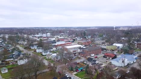 Aerial-view-over-Sheridan-town-in-Hamilton-county-Indiana-with-birds-flying-through-neighbourhood-scene