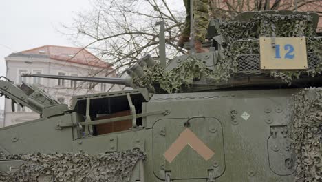 LAV-6-vehicle-on-public-streets-in-Riga,-Latvia,-unrecognizable-soldier-on-top