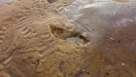 footprint-on-the-beach-disappear-as-it-gets-filled-with-water