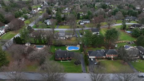 Aerial-view-of-American-neighborhood-in-Lancaster,-Pennsylvania-with-house,-garden-und-swimming-pool-at-cloudy-winter-day,-USA