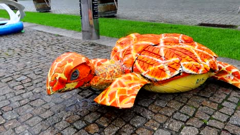 Colorful-turtle-made-of-old-and-used-car-tires-in-Porto,-Portugal