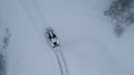 Aerial-top-down-view-of-tractor-plowing-snow-in-a-Artic-environment