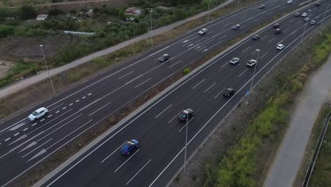 Aerial-drone-shot-of-a-highway-on-the-outskirts-of-the-city-of-Barcelona-with-cars-driving