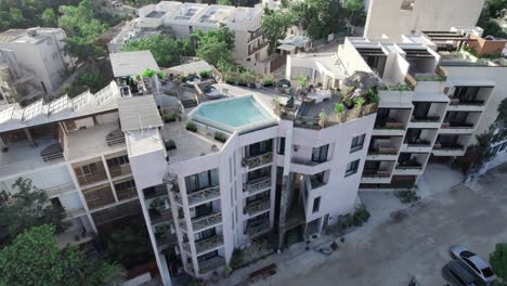Aerial-view-of-modern-apartments-with-a-rooftop-pool-and-solar-plates