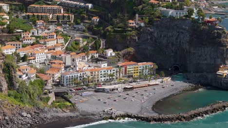 Ponto-do-Sol,-Madeira,-high-angle-drone-view-of-beach-and-town,-sunny-day