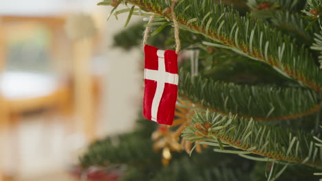 Danish-flag-ornament-hanging-on-a-festive-Christmas-tree