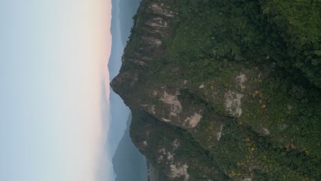 Drohnenporträtansicht-In-Guatemala,-Die-An-Einem-Bewölkten-Tag-In-Atitlan-Vor-Einem-Grünen-Berg-Fliegt,-Der-Von-Vulkanen-Umgeben-Ist