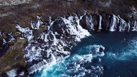 Famous-waterfall-cascade-Hraunfossar-in-Iceland,-aerial-orbit
