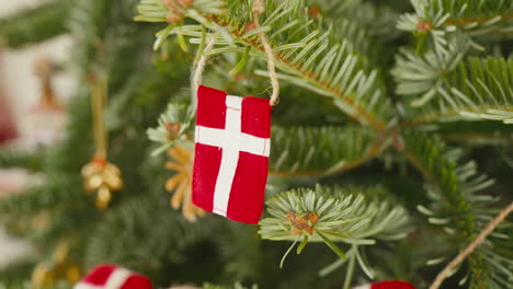 Close-up-of-a-Danish-flag-ornament-on-a-festive-Christmas-tree