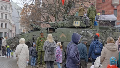 Military-parade,-parked-LAV-6-vehicle-with-people-taking-pictures-with-soldiers