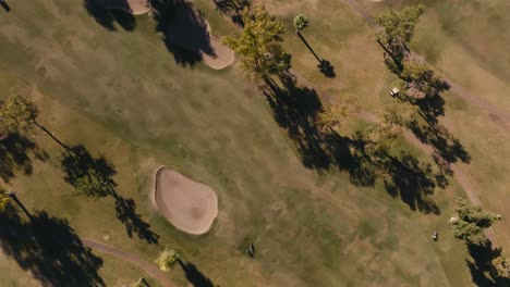 top-down-aerial-drone-shot-of-a-golf-course-with-fairways-and-sand-trap-bunkers