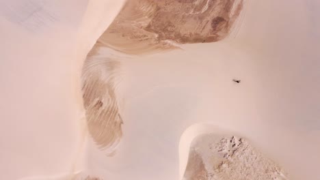 kitesurfer-with-a-yellow-kite-walk-on-a-sanddune-Birdseye-perspective