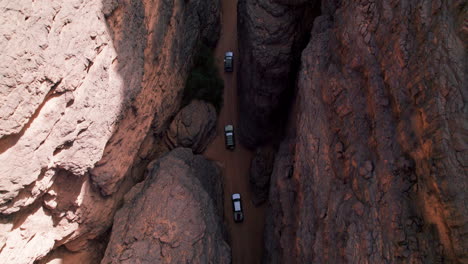 Top-View-Of-Cars-Driving-Amidst-Vast-Plateau-In-Tassili-N'Ajjer-National-Park-In-Southeastern-Algeria