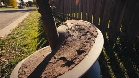closeup-of-a-large-auger-covered-in-dirt-after-digging-a-hole