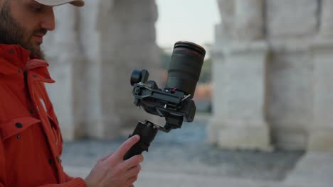 Videographer-with-innovative-DJI-RS3-stabilized-gimbal-with-professional-camera-mounted-outdoors