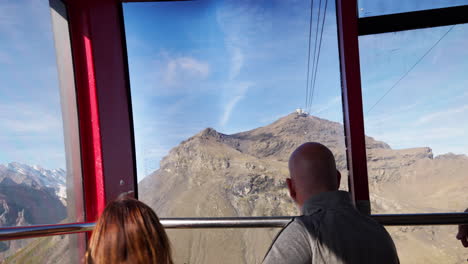 The-breathtaking-views-of-the-mountain-range-are-being-appreciated-by-tourists-as-they-take-a-ride-in-a-cable-car