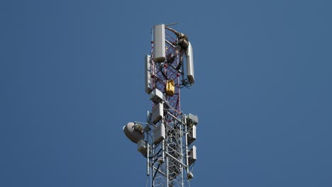 Industrial-alpinist-installing-telecom-antennas-on-communication-tower