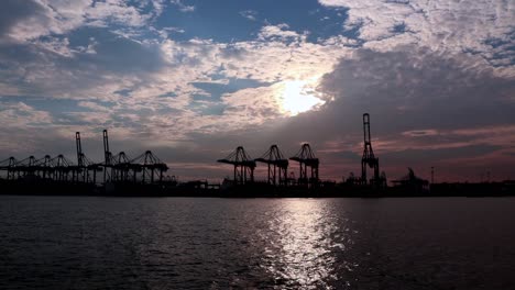 Container-crane-at-Bukom-Island-on-the-sunset-background-behind,-taken-from-Labrador-Jetty