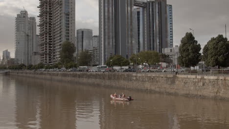 Boat-patrols-river-crossing-from-Buenos-Aires-Capital-Federal-District-into-Downtown-with-amazing-sweeping-view-of-skyscrapers-in-the-distance
