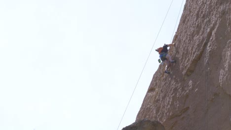 Rock-Climber-Scaling-a-Red-Rock-Structure