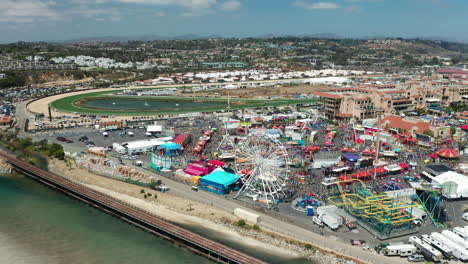 Flyover-of-the-San-Diego-County-Fair-in-Del-Mar-with-the-racetrack-and-mountains-in-the-background
