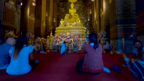 Tourists-photograph-the-golden-Big-Buddha-inside-the-Wat-Pho-Temple-in-Bangkok