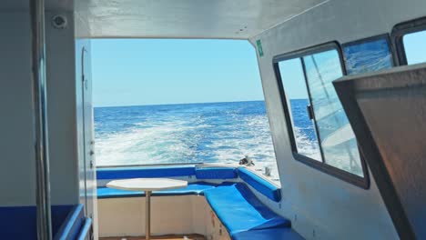 Small-motorboat-cabin-interior,-view-of-deck-and-outdoor-seascape,-Tenerife