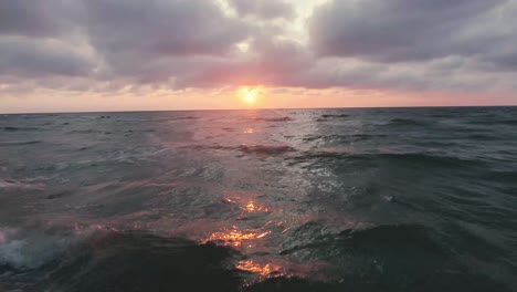 The-drone-slowly-flies-over-the-water-and-shows-the-beautiful-sunset-and-lovely-waves-with-beautiful-colours-in-a-completely-different-perspective
