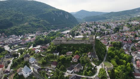 Aerial-view-of-Jajce-Fortress-in-Bosnia-and-Herzegovina,-medieval-walled-city,-orbiting