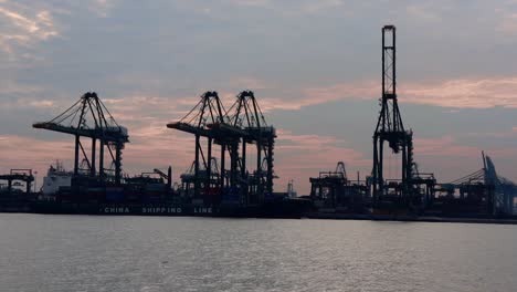 Container-crane-at-Bukom-Island-on-the-sunset-background-behind,-taken-from-Labrador-Jetty