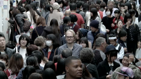 Tilting-up-to-view-a-long-shopping-district-in-Tokyo-crowded-with-people
