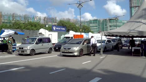 Wide-Shot-of-Cars-Being-Stopped-at-Corona-Virus-Checkpoint-in-Malaysia