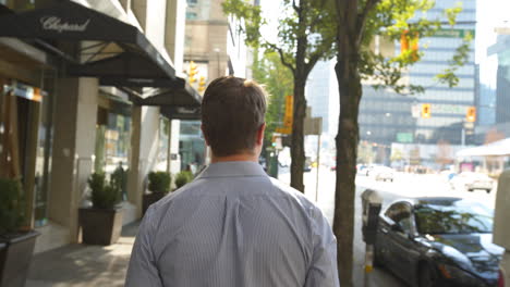 Tracking-Shot-of-Business-Man-Walking-Through-a-Busy-Part-of-Georgia-Street-in-Vancouver