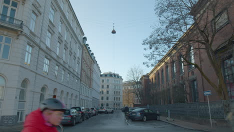 Cyclists-go-past-street-in-Copenhagen,-Denmark