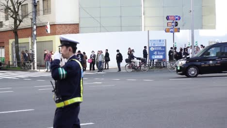Oficial-De-Policía-Guiando-A-Los-Manifestantes-En-Tokio,-Japón