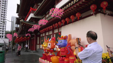 Two-elderly-taking-photos-of-the-new-year-decorations-at-the-temple