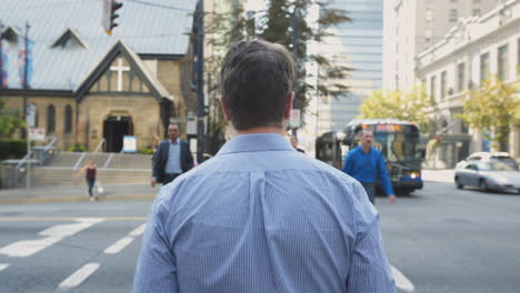 Tracking-Shot-of-Business-Man-Walking-Across-the-Street-Past-Christ-Church-Cathedral-in-Downtown-Vancouver