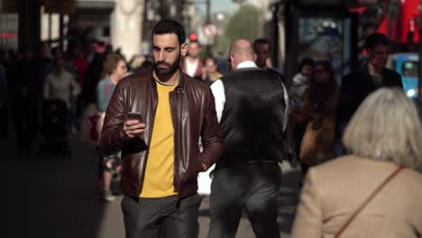 An-Italian-man-with-a-beard-is-walking-toward-the-camera