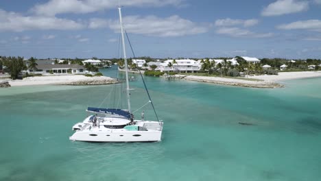 Tourist-Boat-Sailing-on-Tropical-Coast-of-Bahamas,-Aerial-Tracking-Shot