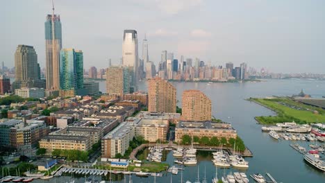 Aerial-Side-Dolly-of-Marina-in-Jersey-City-with-Manhattan-Skyline-at-Dusk